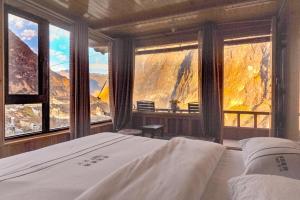 a bedroom with a bed and a view of a mountain at Tibet Guesthouse 虎跳峡卓玛客栈 in Shangri-La