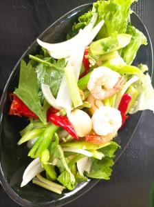 a bowl of salad with vegetables on a table at ริมกว๊านชาเลย์ รีสอร์ทแอนด์คาเฟ่ Rimkwan Chalay Resort and Cafe in Ban Rong Ha