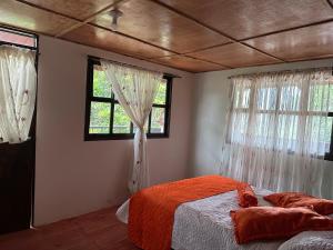 a bedroom with two beds and two windows at sol solegüa in Cajamarca