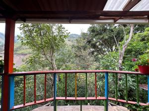a balcony with a view of a forest at sol solegüa in Cajamarca