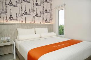 Rúm í herbergi á Front One Hotel Sragen