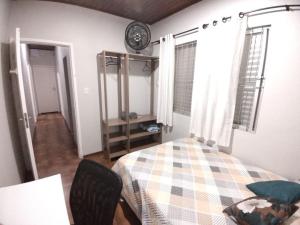 a bedroom with a bed and a table and a clock at ReGaGe in Florianópolis