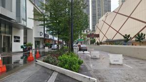 a city street with trees and orange cones at A3. The Sun @ Revo Aurora Pavillion in Kuala Lumpur