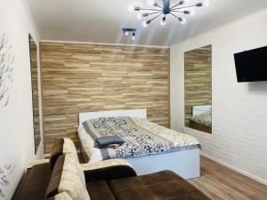 una camera da letto con un letto e una TV a parete di 1-комнатная квартира a Ekibastuz