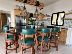 a kitchen with a table and chairs in a kitchen at Villa Tres Vistas. in El Pescadero