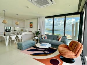 a living room with a couch and a table at Gorgeous 2 bedroom, 17th floor, with breathtaking view, Fourteen at Mullet Bay in Cupecoy