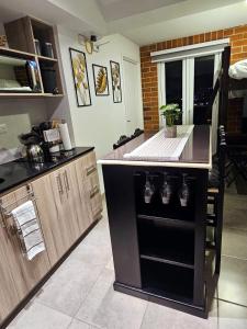 a kitchen with a black island in the middle at Nuevo y Moderno apartamento en la atractiva Zona 4 in Guatemala