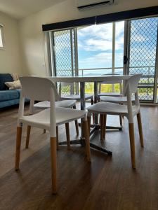 a table and chairs in a room with a window at Wilsons Prom Holiday Park in Yanakie