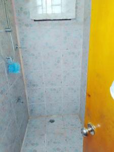 a bathroom with a shower with a tiled floor at Elizabeth Accomodation-Your Home Away from Home in Suva