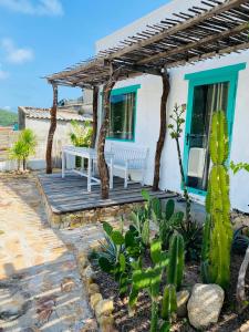 a house with a wooden deck with a bench and cactus at Yeu Bien 3 in Vĩnh Hy