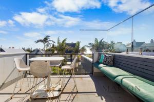 a balcony with a table and chairs on a roof at Entire Home with Views and Heated Pool in Newcastle