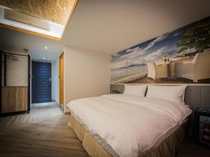 A bed or beds in a room at Good Time Boutique Hotel