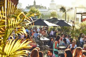 a crowd of people sitting at tables and umbrellas at Studio & Office -Walk anywhere Downtown + Hospital in Montréal