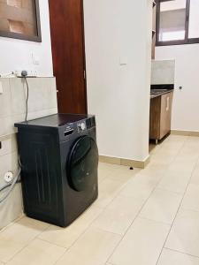 een wasmachine op een vloer in een keuken bij Heavenly Getaways, Nalya in Kampala