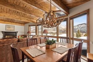 a dining room with a table and a couch at Shadow Mountain 14 in Aspen