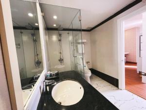 a bathroom with a sink and a mirror at Rivera Boutique Hotel in Da Nang
