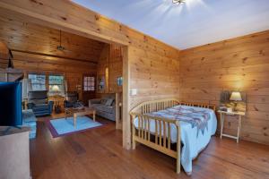 a bedroom with a bed in a room with wooden walls at Peaceful Living Minutes from Blue Ridge hot tub pool table in Blue Ridge