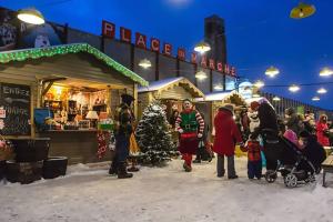 Un gruppo di persone che si trovano di fronte a un mercato natalizio. di Charming 2BR with Balcony in Montreal a Montréal