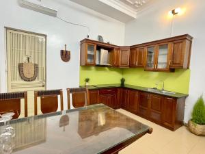 a kitchen with wooden cabinets and a sink in a room at The little Ha Noi in Hanoi +53 photos