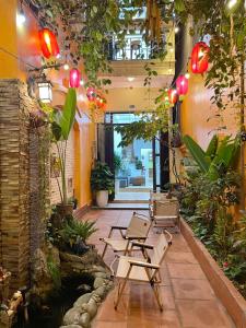 a courtyard with chairs and plants in a building at The little Ha Noi in Hanoi
