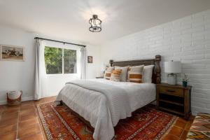 Habitación blanca con cama y ventana en Tropical, Private, Heated pool, Petting zoo!, en Vista