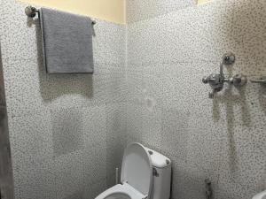 a bathroom with a toilet and a shower at Kankali Viewpoint Resort Pvt Ltd in Kathmandu