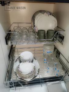 a drawer filled with plates and dishes in a refrigerator at GRANDE MAISON HOMES 2 A'Famosa Golf view Near WATERPARK l UITM l HONDA l Netflix l Self Check in in Kampong Alor Gajah