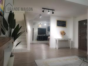 a living room with a table and a chalkboard on the wall at GRANDE MAISON HOMES 2 A'Famosa Golf view Near WATERPARK l UITM l HONDA l Netflix l Self Check in in Kampong Alor Gajah