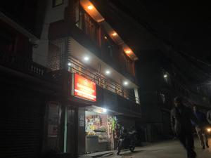 a building with a sign on the side of it at night at Samriddhi HomeStay in Kathmandu