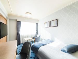 En eller flere senge i et værelse på Senri Hankyu Hotel Osaka