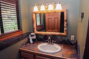 a bathroom with a sink and a mirror at Timber Creek Chalets- 2A chalet in Estes Park