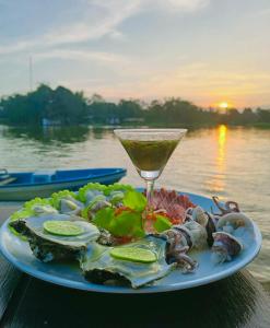 a plate of food and a drink on a table at Baantia Chomtawan in Surat Thani