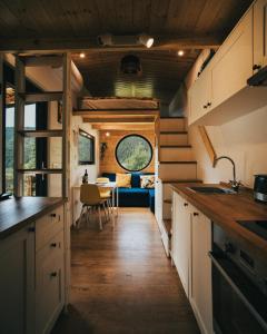 a kitchen with a sink and a dining room at Togethernest Glamping in Mătişeşti