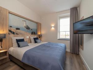 a bedroom with a bed with a bird on the wall at Premium apartment with private wellness in Zeeland in Colijnsplaat