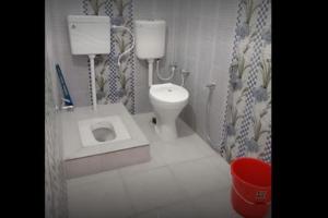 a bathroom with a toilet and a sink at Vivek Palace by StayApart in Barkot