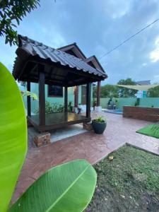 a gazebo with a roof on a patio at CIKNA’s TINY HOUSE in Kuala Terengganu