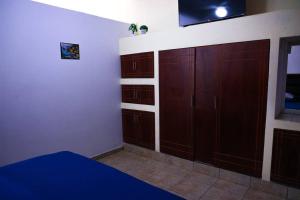 a bedroom with wooden cabinets and a tv on the wall at In the Romantic Zone one block from the beach! in Puerto Vallarta