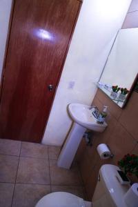 a bathroom with a white toilet and a sink at In the Romantic Zone one block from the beach! in Puerto Vallarta