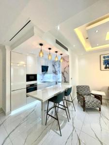 a kitchen with a white table and chairs in a room at Marina Bliss: Stunning Views, By Marina Walk & JBR in Dubai