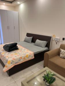a living room with a bed and a couch at Hello studio in Noida