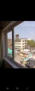a window in a room with a view of a city at New hotel blue stars in Varanasi