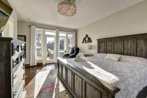 a bedroom with a large bed and a chair at Short Term Rental Approved. Stay Worry Free! in Kelowna