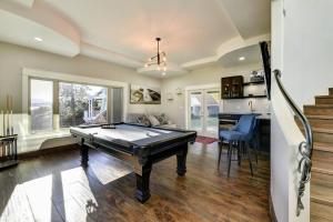 a living room with a pool table in it at Short Term Rental Approved. Stay Worry Free! in Kelowna