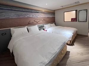 A bed or beds in a room at Good Time Boutique Hotel
