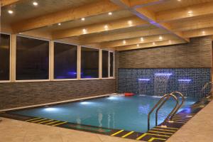 a indoor swimming pool in a building with at Marigold Sarovar Portico Shimla in Shimla
