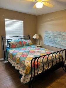 a bedroom with a bed and a ceiling fan at Pelican hut in Panama City