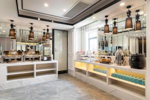 a kitchen with a counter with many different appliances at Xana Hotelle - Guangzhou Jiangnanxi Metro Station in Guangzhou