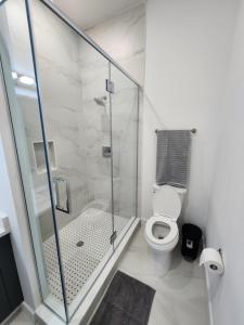 a bathroom with a shower and a toilet at Luxury 2 bedroom apartment, close to NYC! in Bayonne