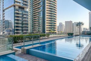 a swimming pool in a city with tall buildings at Frank Porter - RP Heights in Dubai