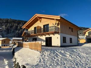 a house with a balcony in the snow at Chalet in Hermagor with nice views and sauna in Hermagor